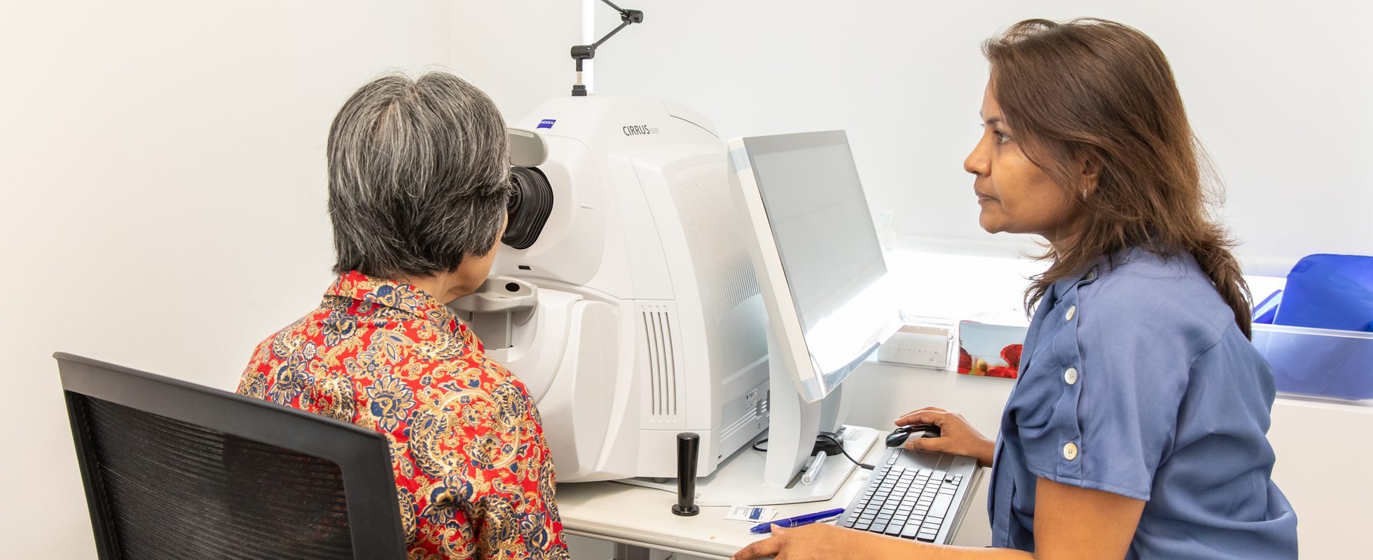 Eastwood Eye Surgery clinician capturing an optical coherence tomography scan of a patient's eye during a cataract assessment