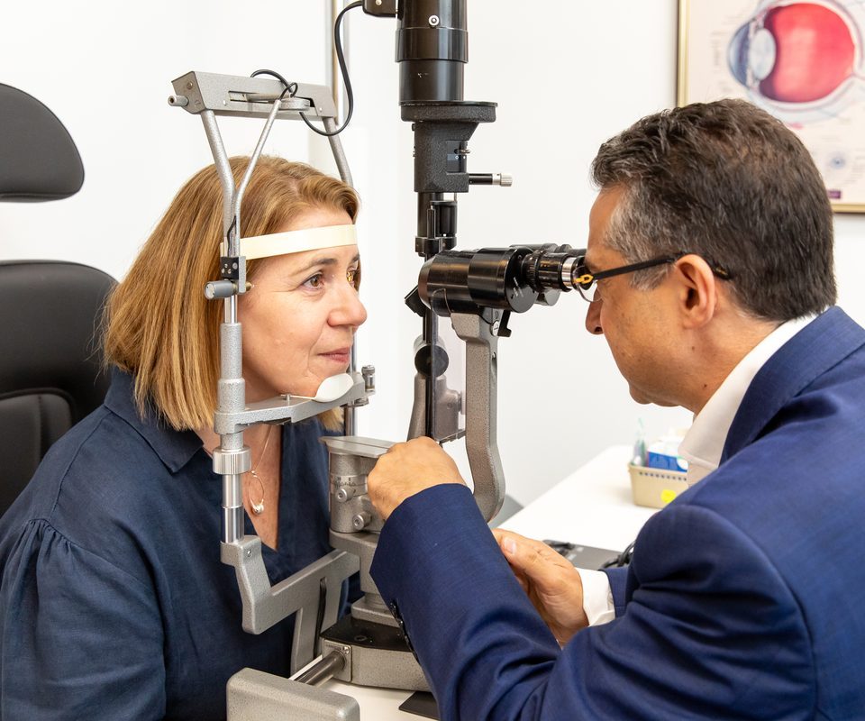 Eastwood Eye Surgery ophthalmologist examining a patient's eye at the slit lamp during a cataract assessment