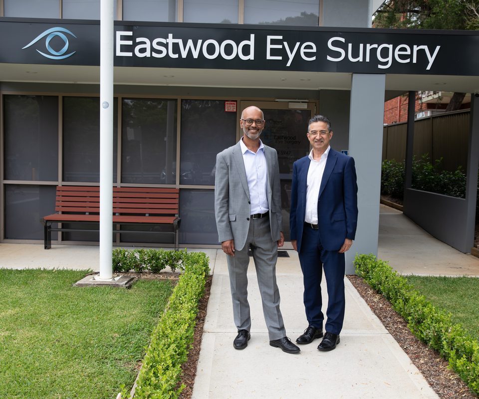 Two Eastwood Eye Surgery ophthalmologists standing outside the practice entrance on East Parade