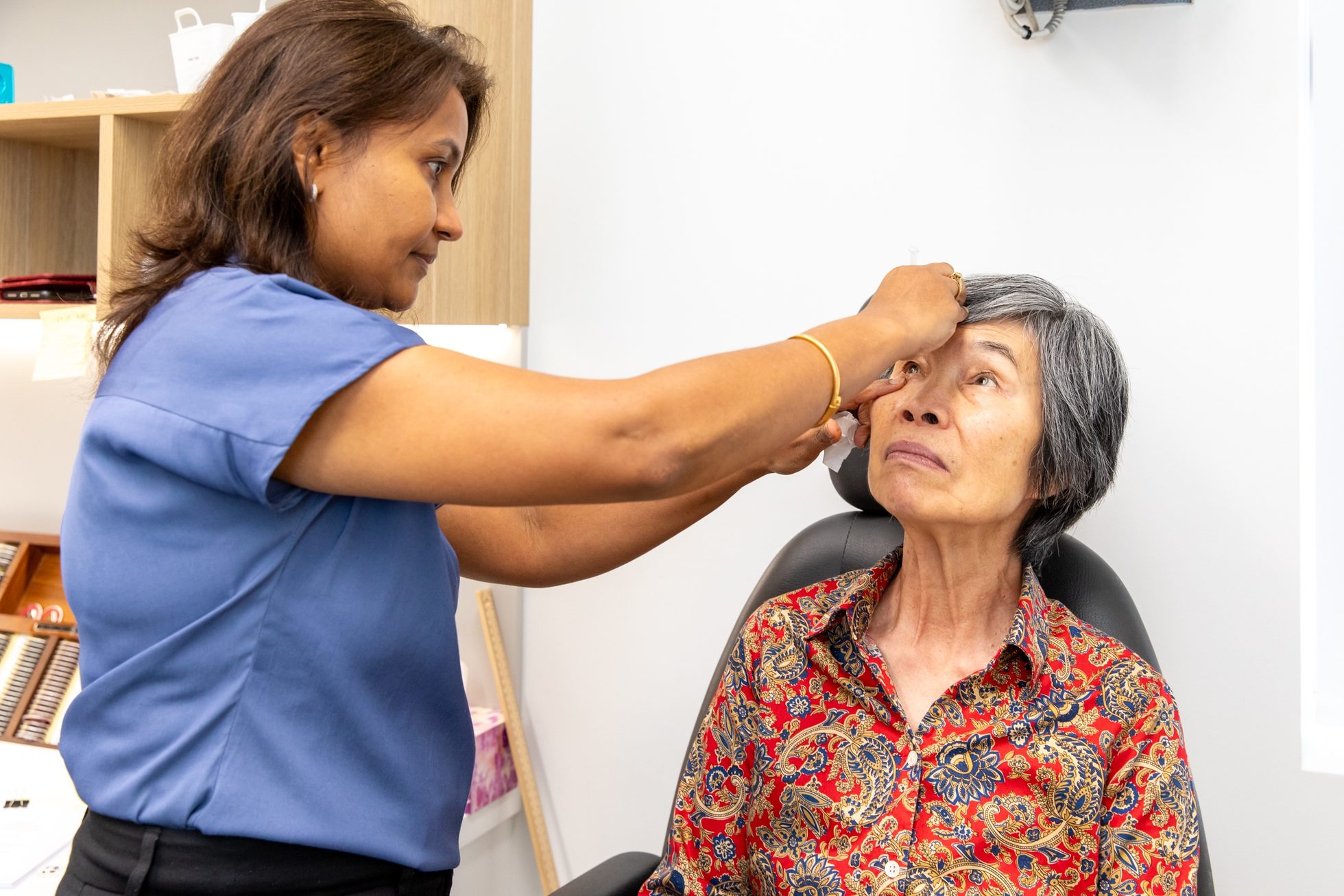 Eastwood Eye Surgery clinician instilling dilating drops into a patient's eye before a retinal examination