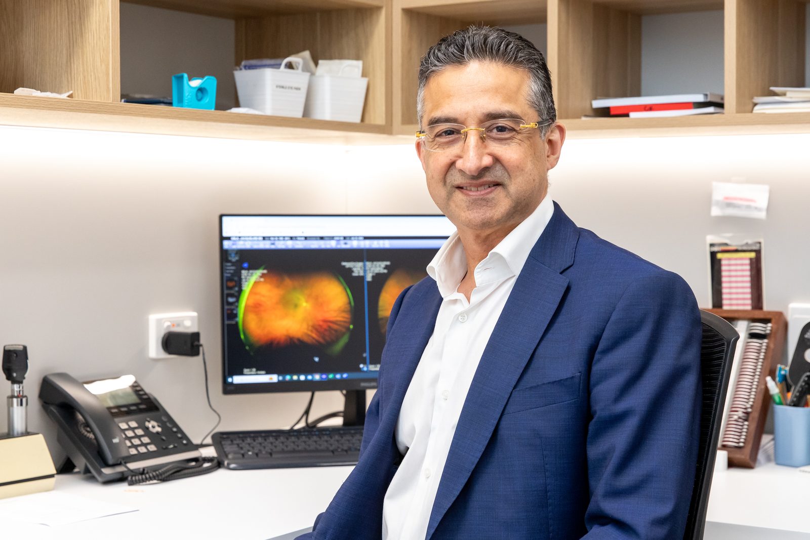 Ophthalmologist reviewing a retinal image of the optic nerve on screen when planning glaucoma treatment