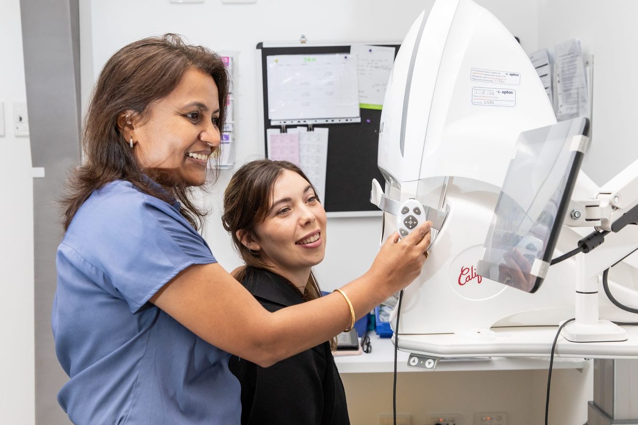 Two Eastwood Eye Surgery staff operating an Optos wide-field retinal imaging camera