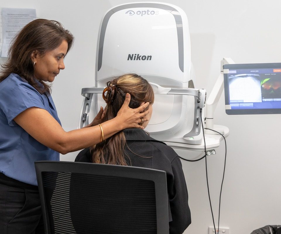Eastwood Eye Surgery clinician positioning a patient at a wide-field retinal imaging camera