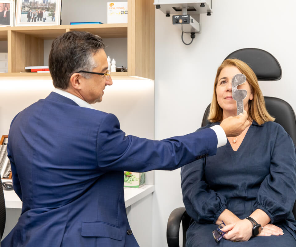 Eastwood Eye Surgery ophthalmologist examining a patient's eye at the slit lamp during a cataract assessment
