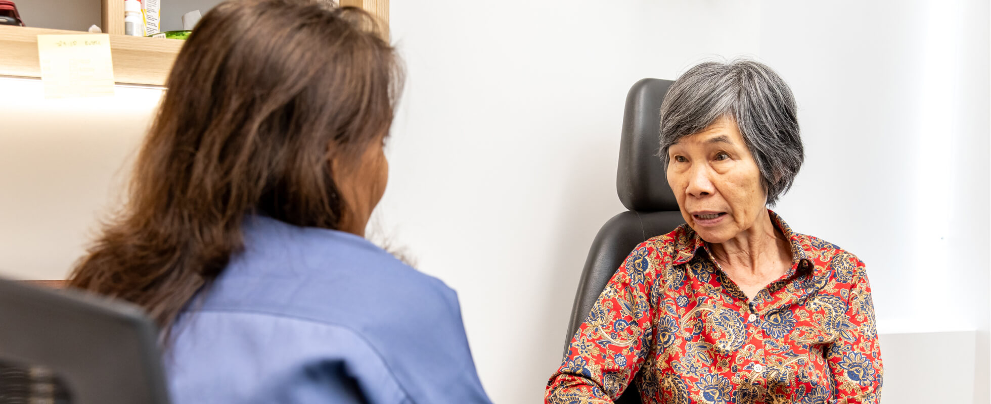 Eastwood Eye Surgery clinician instilling dilating drops into a reclined patient's eye before a diabetic retinal examination
