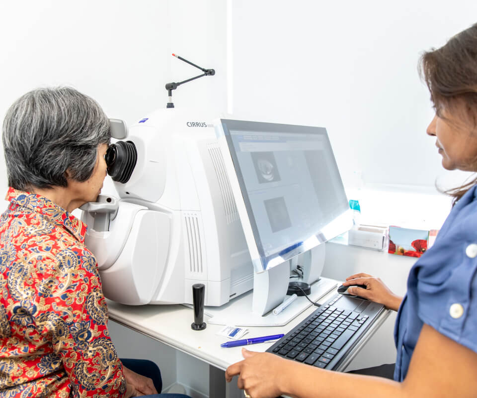 Eastwood Eye Surgery ophthalmologist examining a patient's eye at the slit lamp during a cataract assessment