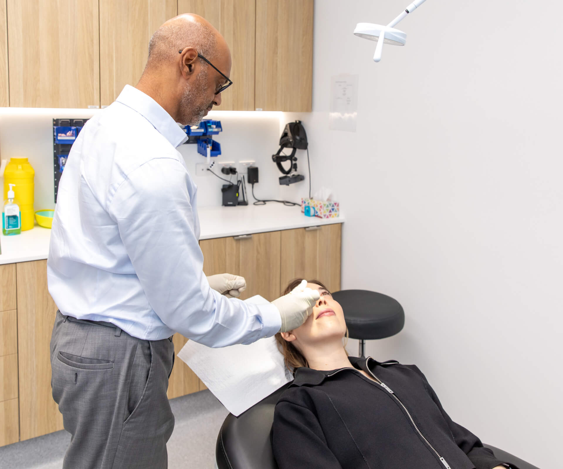 Eastwood Eye Surgery ophthalmologist examining a patient's eye at the slit lamp during a cataract assessment